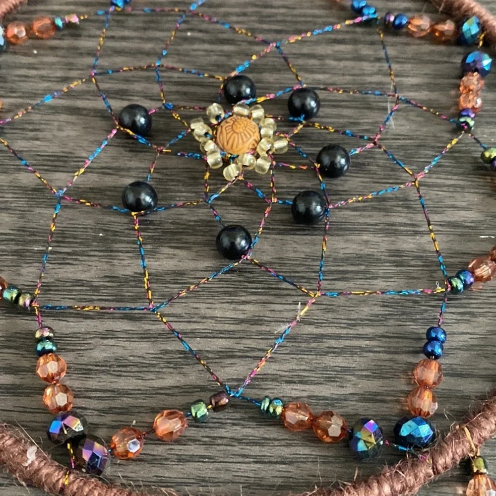 Dream catcher. Blue and tan feathers beaded. Beautiful!